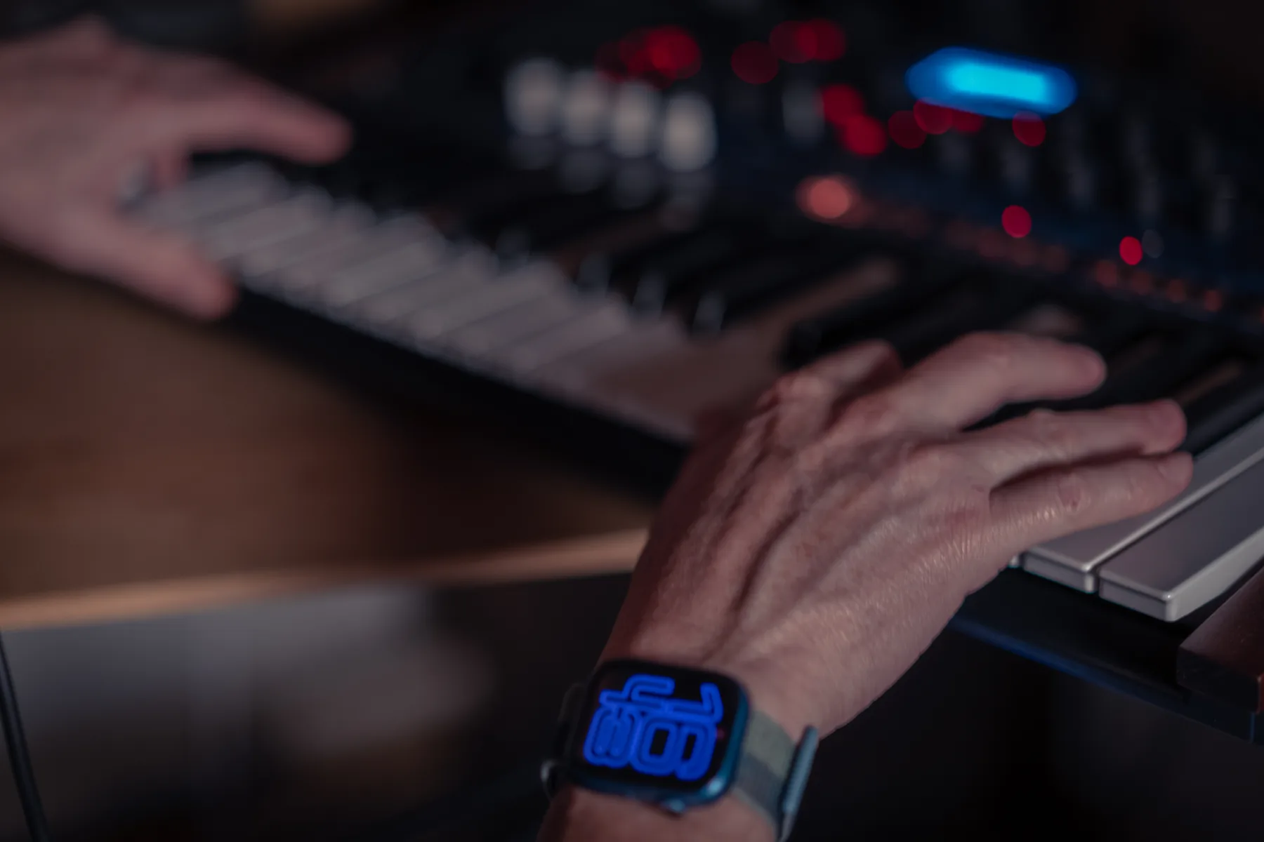 Hands shaping sound on a synthesizer in the Estana Music studio